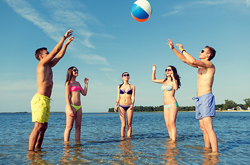 Image showing smiling friends in sunglasses on summer beach