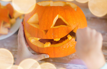 Image showing close up of woman with pumpkins at home