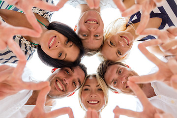 Image showing smiling friends in circle