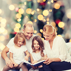 Image showing happy family with book at home