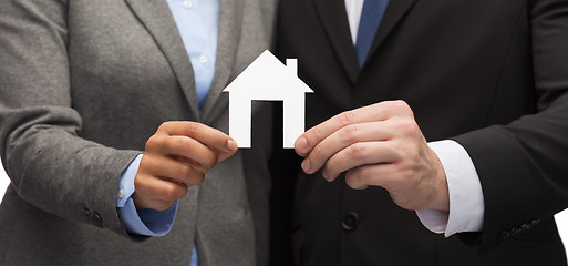 Image showing businessman and businesswoman holding white house