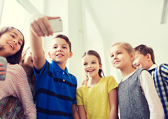 Image showing group of school kids taking selfie with smartphone