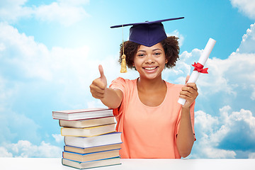 Image showing happy african bachelor girl with books and diploma