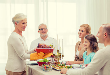 Image showing smiling family having holiday dinner at home