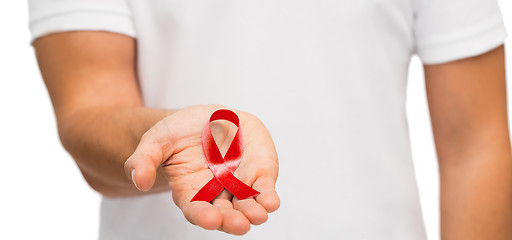 Image showing hand with red aids or hiv awareness ribbon