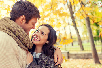 Image showing smiling couple hugging in autumn park