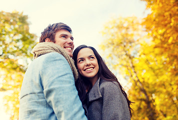 Image showing smiling couple hugging in autumn park