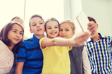 Image showing group of school kids taking selfie with smartphone