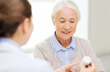 Image showing doctor with medicine and senior woman at hospital