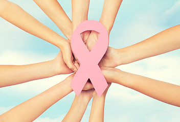 Image showing close up of hands with cancer awareness symbol