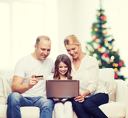 Image showing happy family with laptop computer