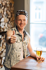 Image showing happy man with beer showing thumbs up at bar