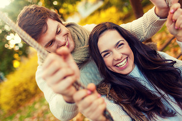 Image showing smiling couple hugging in autumn park