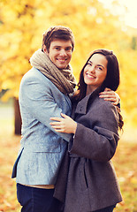 Image showing smiling couple hugging in autumn park