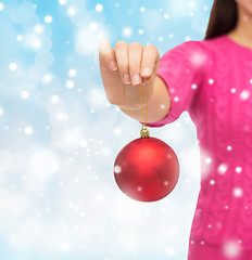 Image showing close up of woman in sweater with christmas ball