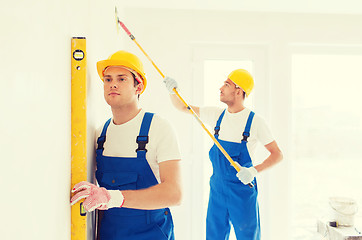 Image showing group of builders with tools indoors