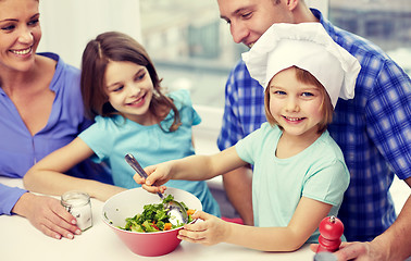 Image showing happy family with two kids cooking at home