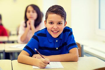 Image showing group of school kids writing test in classroom