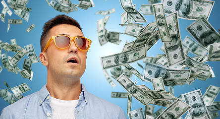 Image showing surprised man under dollar money rain