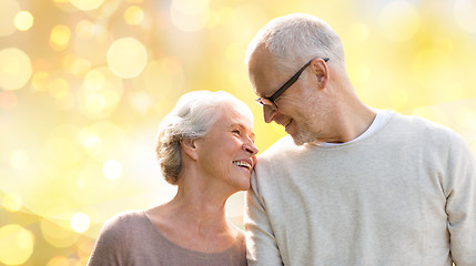 Image showing happy senior couple over holiday lights background