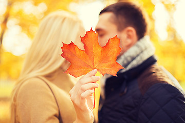 Image showing close up of couple kissing in autumn park