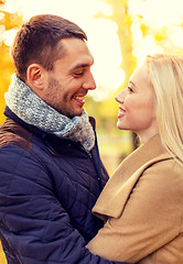 Image showing smiling couple hugging in autumn park