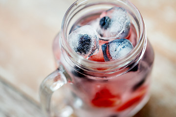 Image showing close up of fruit water in glass mug on table