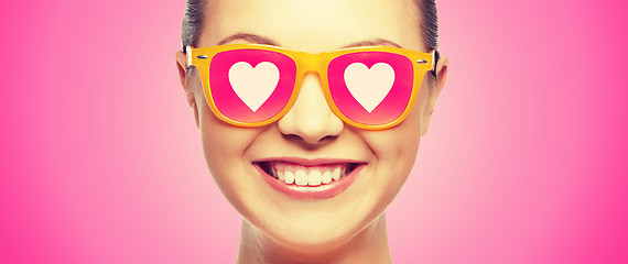 Image showing smiling teenage girl in pink sunglasses