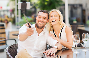Image showing happy couple taking selfie with smartphone at cafe