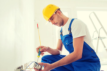 Image showing builder with tablet pc and equipment indoors