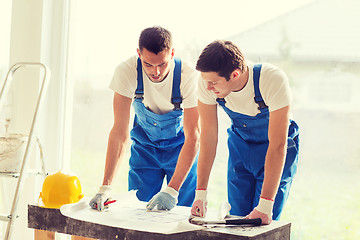 Image showing group of builders with blueprint