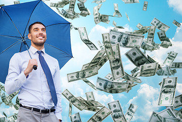 Image showing young smiling businessman with umbrella outdoors