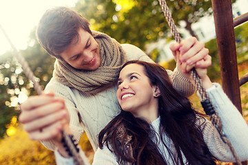 Image showing smiling couple hugging in autumn park