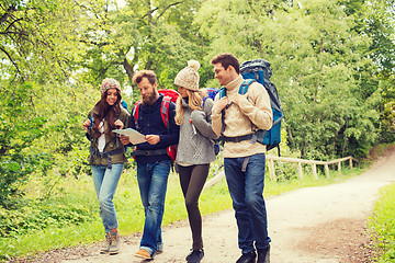 Image showing group of smiling friends with backpacks hiking