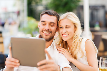 Image showing happy couple with tablet pc at restaurant lounge