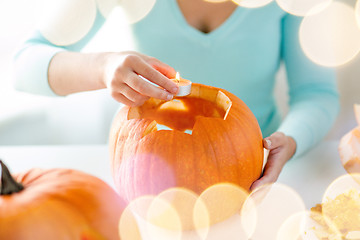 Image showing close up of woman with pumpkins at home