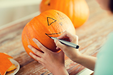 Image showing close up of woman with pumpkins at home