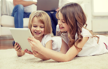 Image showing happy little girls with tablet pc computer at home
