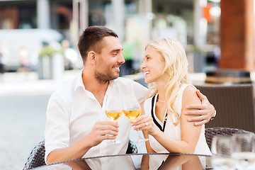 Image showing happy couple clinking glasses at restaurant lounge