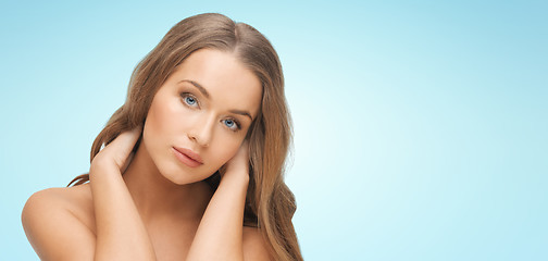 Image showing beautiful young woman face over blue background