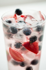 Image showing close up of fruit water with ice cubes in glass