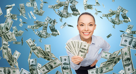 Image showing smiling businesswoman with dollar cash money