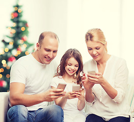 Image showing happy family with smartphones