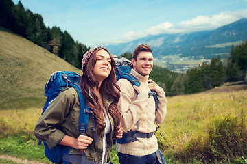 Image showing smiling couple with backpacks hiking