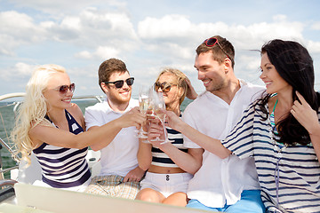 Image showing smiling friends with glasses of champagne on yacht