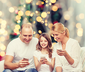 Image showing happy family with smartphones