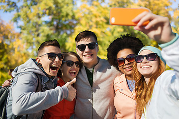 Image showing smiling friends taking selfie with smartphone