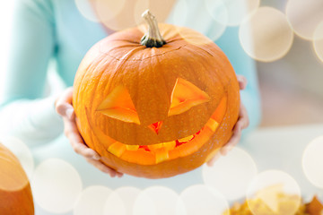 Image showing close up of woman with pumpkins at home