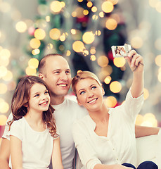 Image showing happy family with camera at home