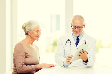 Image showing smiling senior woman and doctor with tablet pc